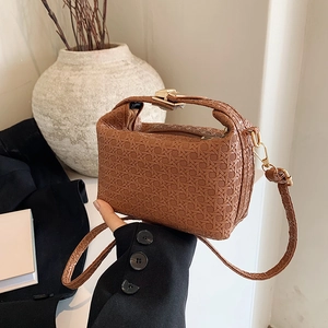 Brown woven texture handbag with gold buckle and top handle for elegant crossbody wear