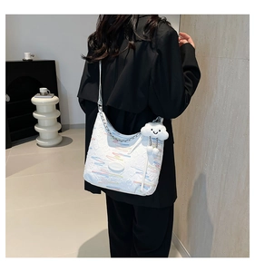 Detail of canvas bucket bag with colorful wavy embroidery and cute cloud charm