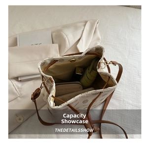 Top view of beige drawstring bucket bag showing spacious interior with wallet and umbrella