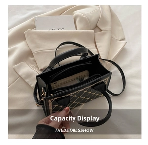 Detail view of the spacious interior capacity of this quilted black shoulder bag