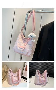Pink pleated canvas shoulder bag with colorful jacquard lines and plush cloud charm