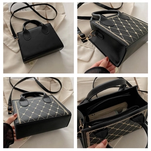 Detail of black crossbody bag with gold heart quilting and interior zipper compartment
