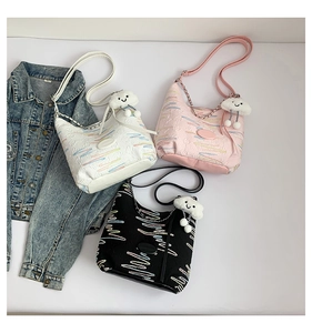 Detailed shot of striped canvas bucket bags in black, white and pink with cloud charms