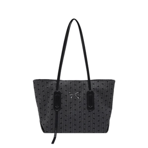 Chic dark grey tote bag with black stripes and silver bow logo on a white background
