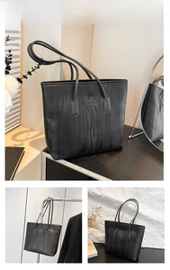 Detail of black tote bag showing wavy texture surface and branded leather patch