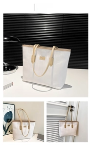 Detail view of khaki leather trim and textured vertical stripes on the tote bag