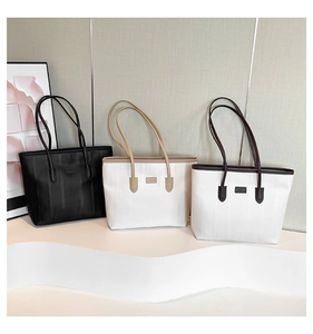 Three large tote bags with vertical textures in black, beige, and cream colors