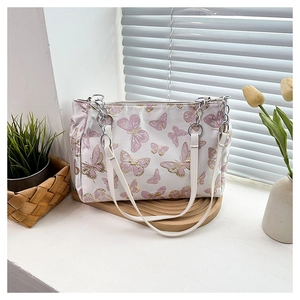 Detail of silk shoulder bag with butterfly embroidery and silver metal rings