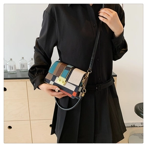 Detail of color-block plaid crossbody bag featuring a golden square twist lock
