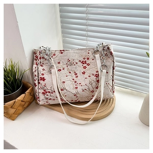 Detail of Chinese style embroidery floral patterns on ivory jacquard fabric tote bag