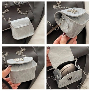 Detail view of mini butterfly crossbody bag showing metallic texture and inner capacity