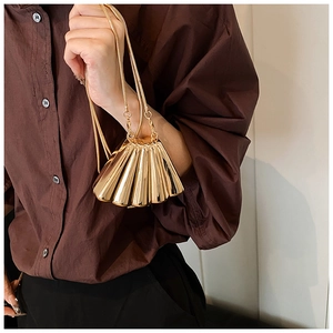 Elegant gold shell-shaped evening bag with metallic mirror finish and thin chain strap