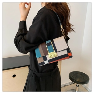 Chic color-block handbag with geometric patterns and golden buckle on model