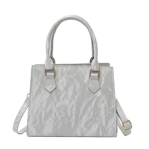 Minimalist light grey crossbody bag with wrinkled texture and dual handles