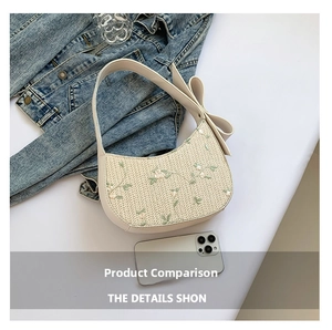 Close-up of floral embroidery and oversized bow detail on cream lace underarm bag