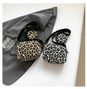 Detail of leopard print shoulder bag set with detachable round coin purse and strap
