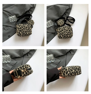 Detail of leopard print shoulder bag set with detachable round coin purse and gold hardware