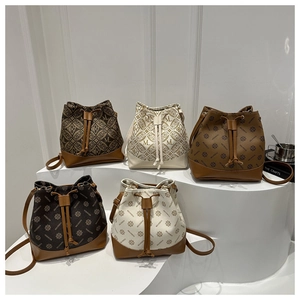 Detailed arrangement of monogram bucket bags with drawstring closure on white stands