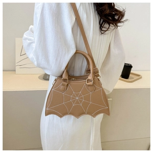 Detail of camel shoulder bag with spider web embroidery and wavy bat-shaped bottom edge