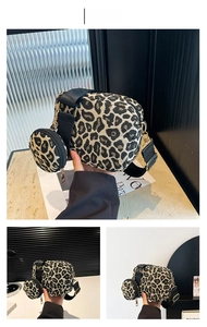 Detail view of leopard print baguette bag with a round coin purse and gold hardware