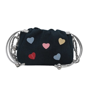 Denim shoulder bag with colorful heart patches and silver metal handles for casual styling