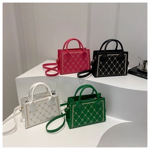 Detail showing four quilted tote bags with heart patterns in fuchsia, black, white, and green