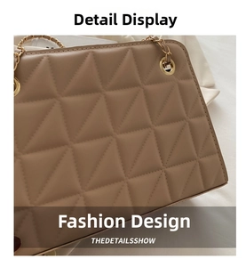Detailed close-up of beige quilted leather crossbody bag with golden chain and fine stitching