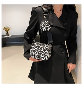 Detail of leopard print handbag with detachable round coin purse and black wide strap