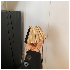 Elegant gold shell-shaped clutch bag with pleat details and metallic chain strap