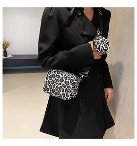 Detail of leopard print crossbody bag set with wide woven strap and small round coin purse
