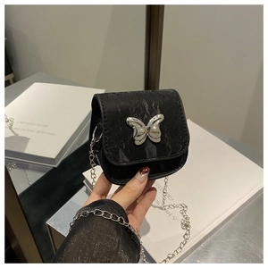 Close-up of black marble texture crossbody bag with silver butterfly metal detail