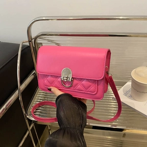 Quilted magenta leather crossbody bag with silver rotating lock in urban style