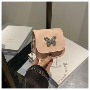 Close-up of pink mini crossbody bag featuring a silver mirror metal butterfly ornament