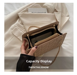 Top view of beige quilted bag interior showing central zipper pocket and large capacity