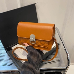 Brown quilted crossbody bag with silver buckle and elegant leather texture