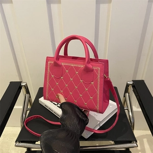 Hot pink quilted crossbody bag with golden heart embroidery and versatile strap