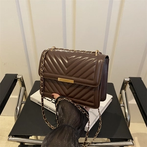 Dark brown chevron quilted shoulder bag with gold hardware and a metal chain strap