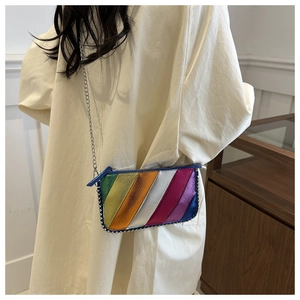 Close-up of a rainbow leather chain bag with silver beaded trim and textured finish