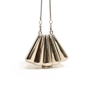 Silver shell-shaped metal chain evening bag with sleek radial texture and shoulder strap