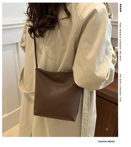Detail showing the brown lychee leather texture and FASHION & BAGS logo on the crossbody bag