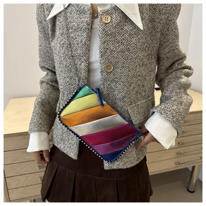 Detail of metallic rainbow patchwork small crossbody bag with silver chain and stud trim