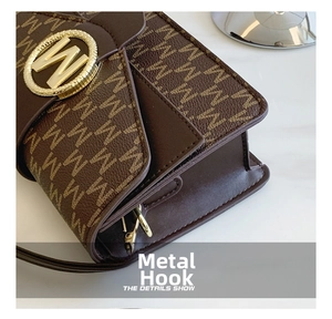 Detailed close-up of premium gold hardware hook and letter print on brown leather bag