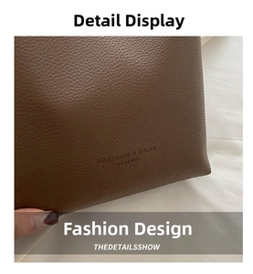 Detail of brown litchi grain leather texture and embossed fashion typography logo