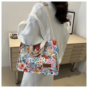 Detail of floral canvas tote bag showing large capacity and comfortable woven straps