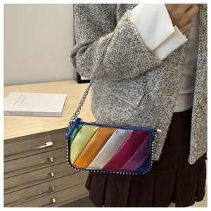 Detail of rainbow metallic chain bag with silver rivets and textured paneling on side