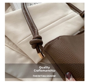 Close-up of brown pebbled leather texture and knotted rope strap with gold metal ends