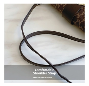 Close-up of the slim dark brown leather shoulder strap on a classic monogram bag