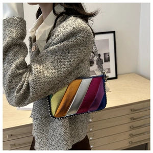 Detail of colorful metallic striped shoulder bag with silver beaded edge and chain strap