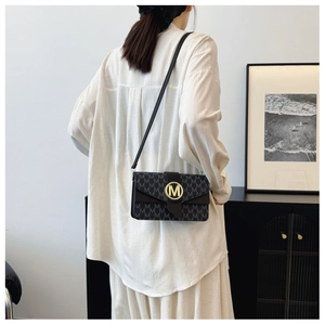 Fashionable black square crossbody bag with letter M monogram pattern and gold logo buckle