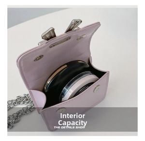Internal view of mini pink bow bag showing capacity for makeup and silver chain